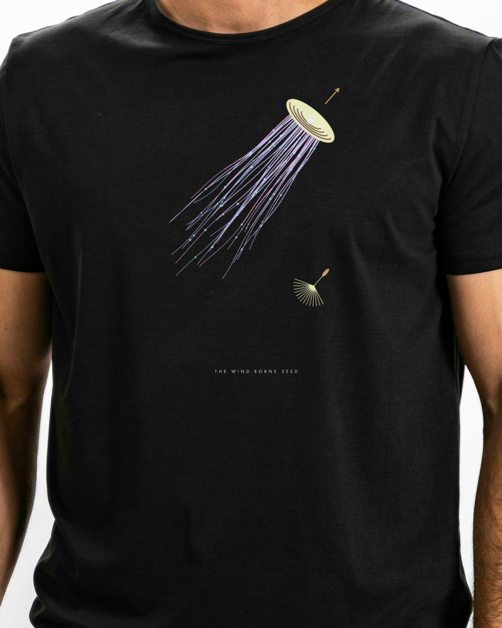 Model photo of the The Wind-Borne Seed Tee: illustrative, print shown at actual size
